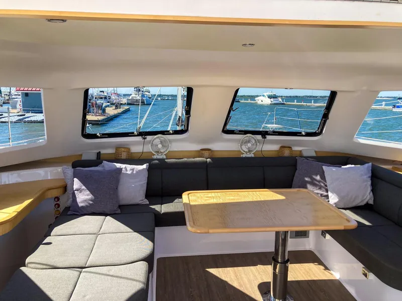 Slide: The Image of Interior of 2023 Seawind 1260 catamaran with spacious seating and ocean view. - 43