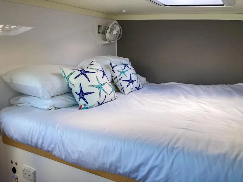 Slide: The Image of Cozy bedroom in 2023 Seawind 1260 catamaran with starfish-themed pillows. - 46