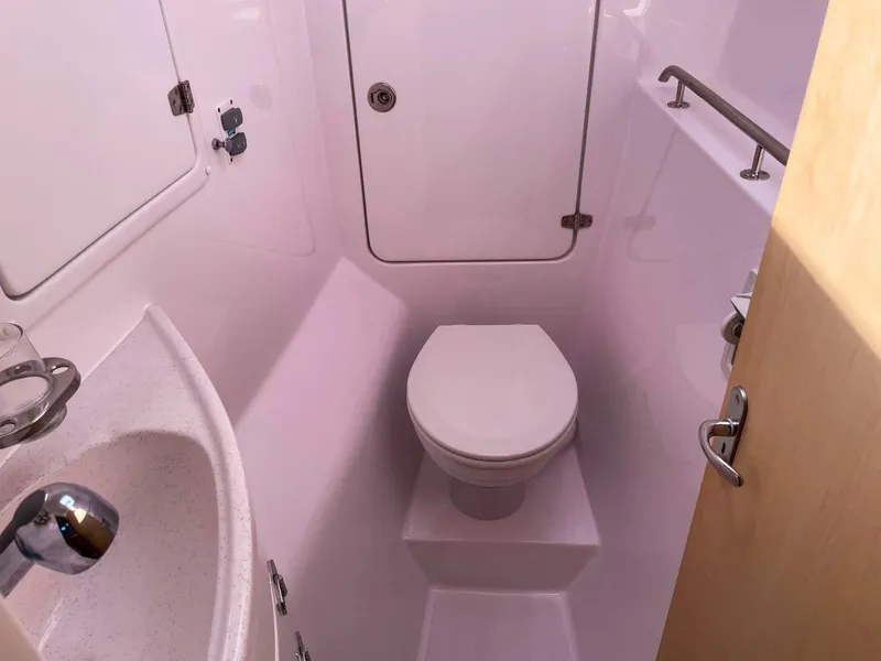 Slide: The Image of 2023 Seawind 1260 yacht bathroom with toilet, sink, and storage. - 48