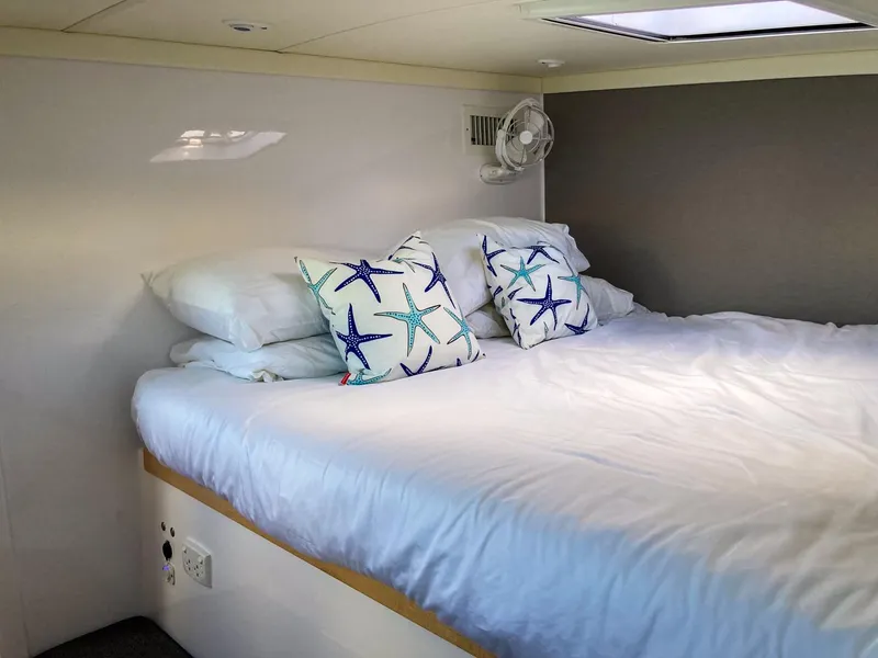 Slide: The Image of Cozy bedroom in 2023 Seawind 1260 catamaran with starfish-themed pillows. - 49