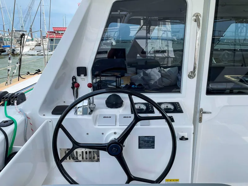 Slide: The Image of 2023 Seawind 1260 yacht helm with steering wheel and navigation controls. - 5
