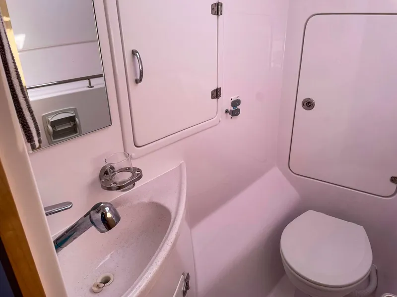 Slide: The Image of 2023 Seawind 1260 yacht bathroom with sink, mirror, and toilet. - 50