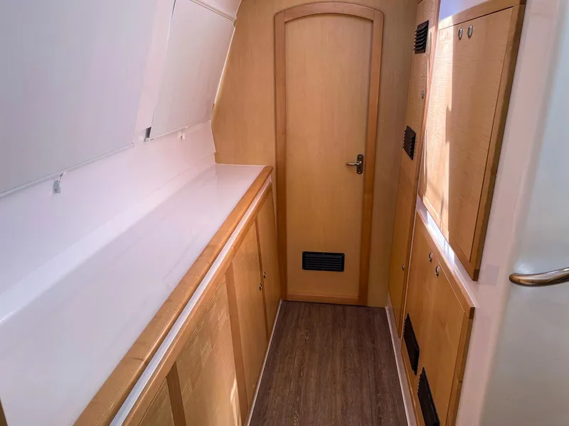 Slide: The Image of Interior of 2023 Seawind 1260 catamaran with wooden cabinetry and sleek design. - 53