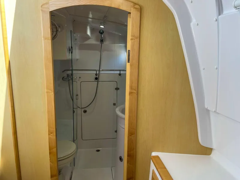 Slide: The Image of 2023 Seawind 1260 yacht bathroom with shower, wooden trim, and modern fixtures. - 57