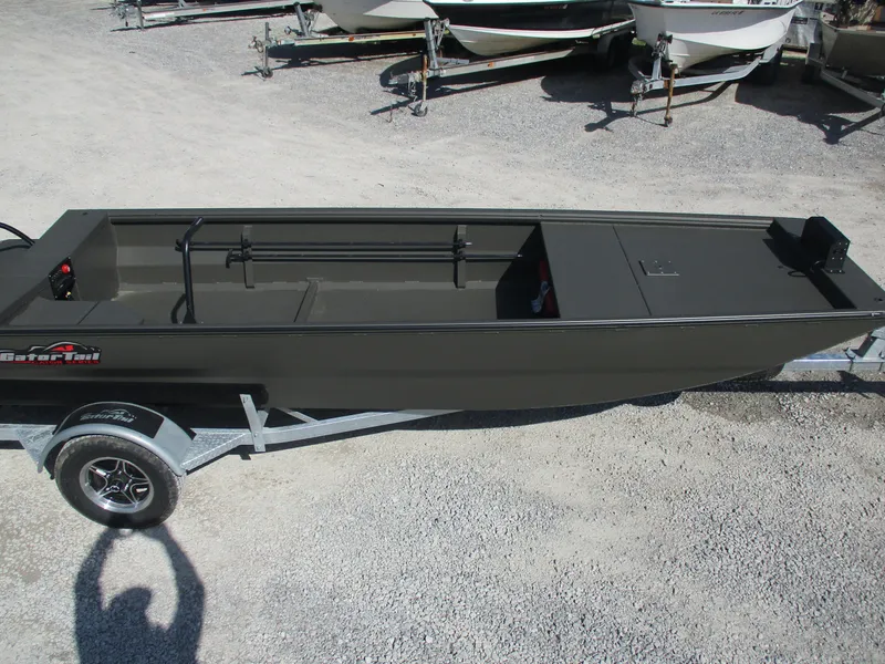 Slide: The Image of 2025 Gator Tail 1748 GATOR boat on trailer, parked on gravel surface. - 3