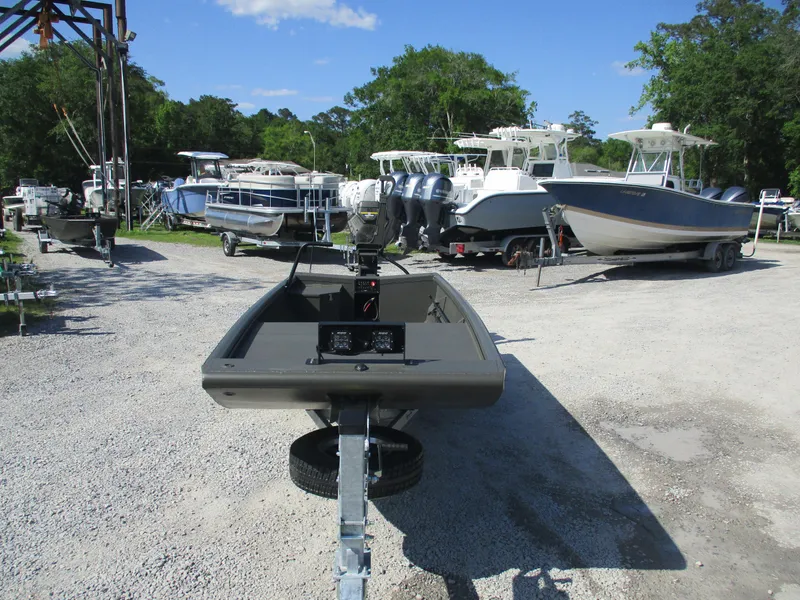 Slide: The Image of 2025 Gator Tail 1748 GATOR boat on trailer in a marina with other boats. - 4