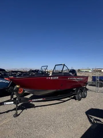 Slide: The Image of 2023 Tracker Pro Guide V-175 WT boat on trailer under clear blue sky. - 6