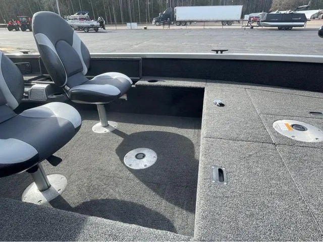 Slide: The Image of 2016 Alumacraft Classic 165 TL boat interior with seating and storage compartments. - 11