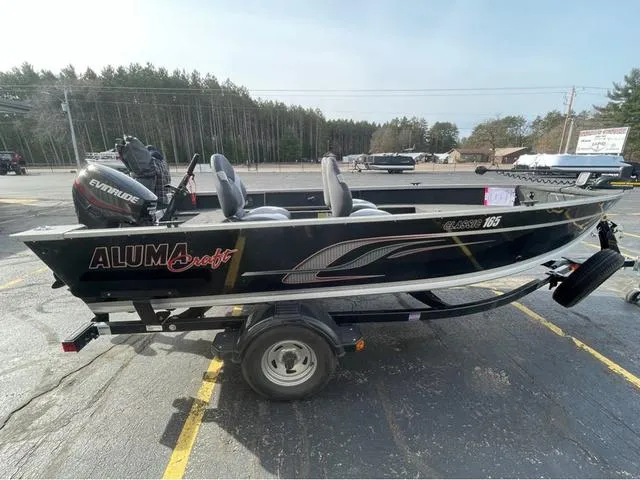 Slide: The Image of 2016 Alumacraft Classic 165 TL boat on trailer, parked outdoors. - 4