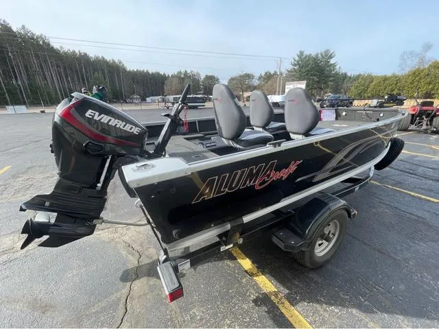 Slide: The Image of 2016 Alumacraft Classic 165 TL boat with Evinrude motor in parking lot. - 5