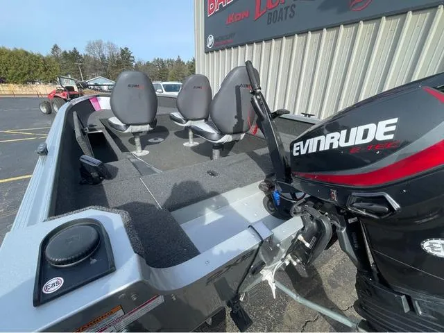 Slide: The Image of 2016 Alumacraft Classic 165 TL boat with Evinrude engine, parked outside a building. - 7