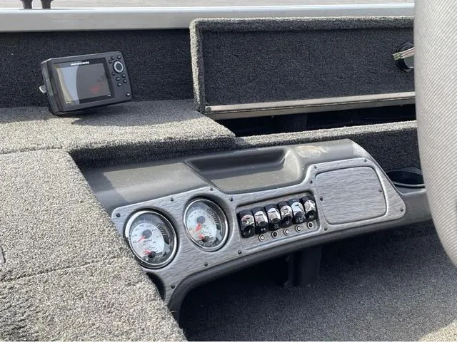 Slide: The Image of Dashboard of a 2016 Alumacraft Classic 165 TL boat with gauges and controls. - 8