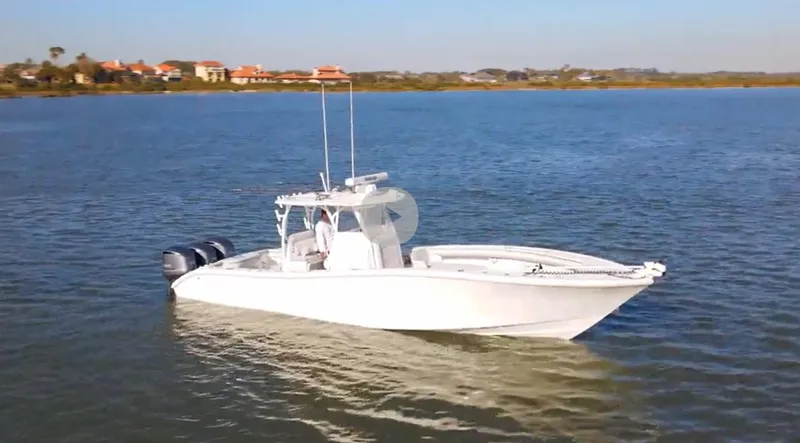 Slide: The Image of 2017 Yellowfin 34 Offshore boat on calm water, clear sky background. - 1