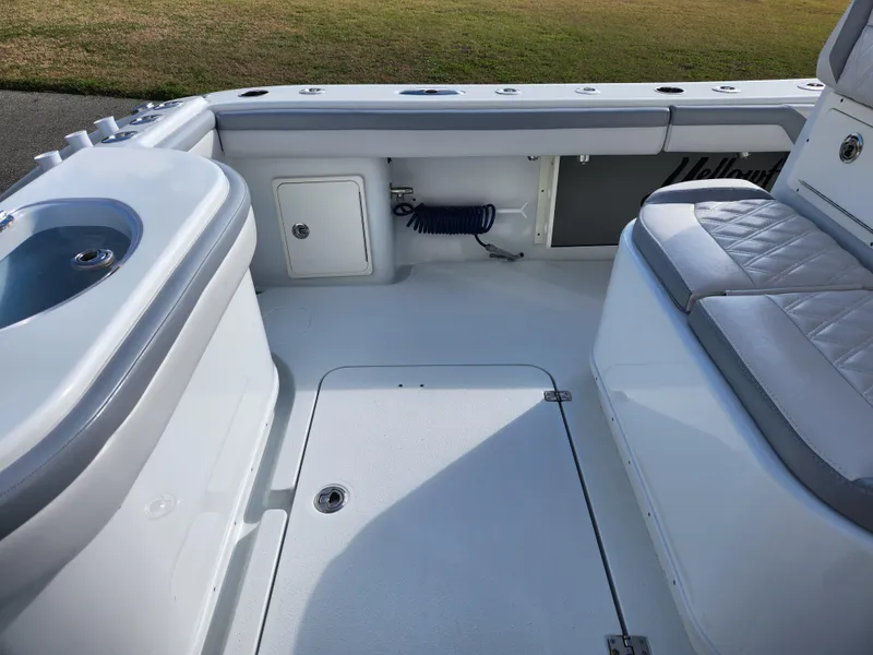 Slide: The Image of 2017 Yellowfin 34 Offshore boat interior with seating and storage compartments. - 21