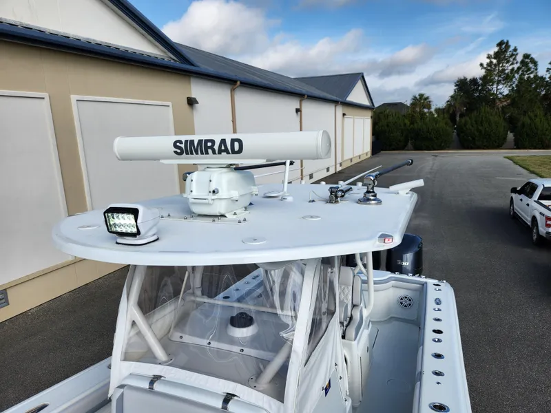 Slide: The Image of 2017 Yellowfin 34 Offshore boat with Simrad radar, parked near buildings. - 27