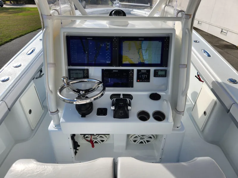 Slide: The Image of 2017 Yellowfin 34 Offshore boat console with navigation screens and steering wheel. - 29