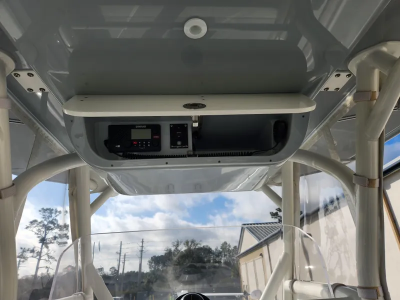 Slide: The Image of 2017 Yellowfin 34 Offshore boat console with electronic controls and overhead storage. - 31