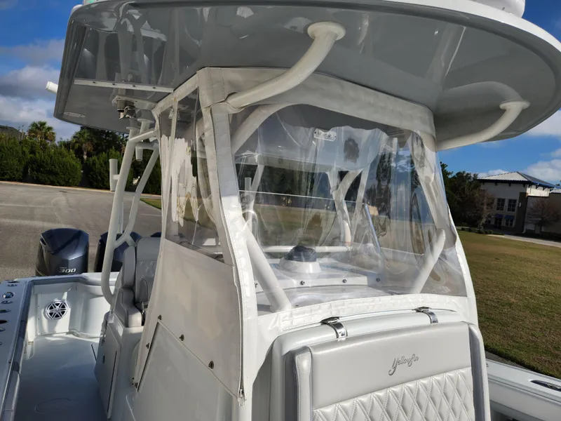 Slide: The Image of 2017 Yellowfin 34 Offshore boat with enclosed helm and clear protective panels. - 37