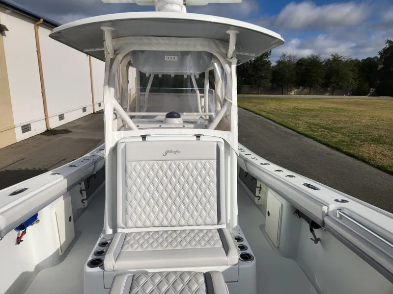Slide: The Image of 2017 Yellowfin 34 Offshore boat with white seating and spacious deck. - 45