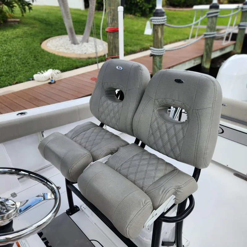 Slide: The Image of 2021 Sportsman Open 252 Center Console boat seats with quilted gray upholstery. - 15