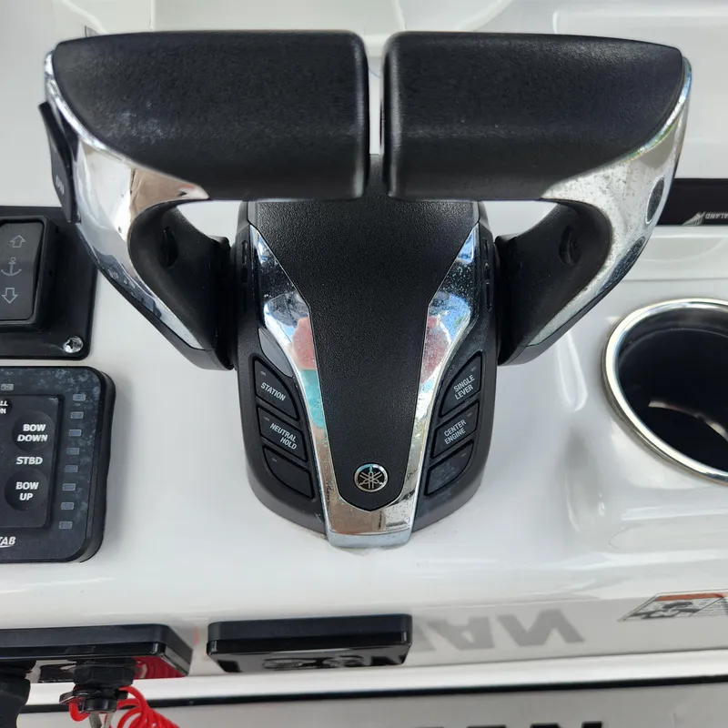 Slide: The Image of Throttle controls on a 2021 Sportsman Open 252 Center Console boat dashboard. - 23