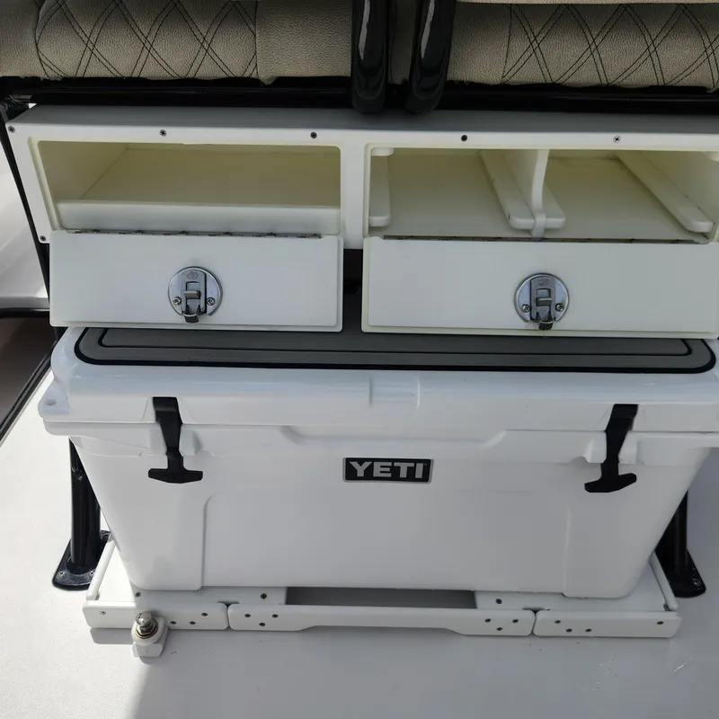 Slide: The Image of 2021 Sportsman Open 252 Center Console with Yeti cooler and storage compartments. - 26
