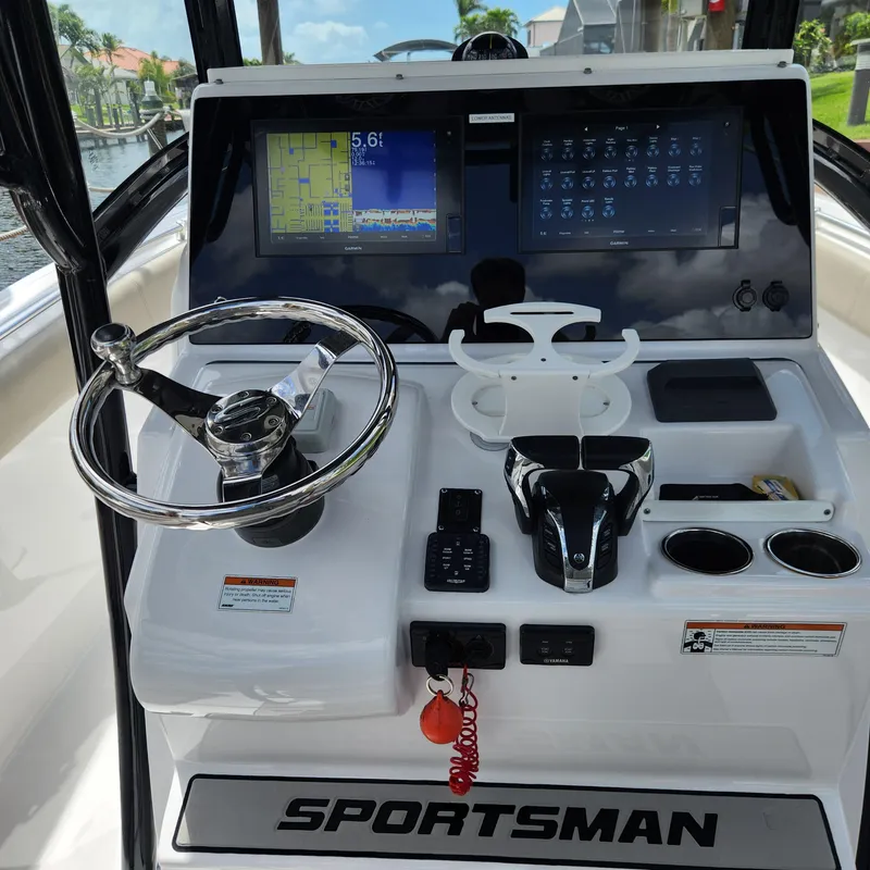 Slide: The Image of 2021 Sportsman Open 252 Center Console dashboard with steering wheel and navigation screens. - 27