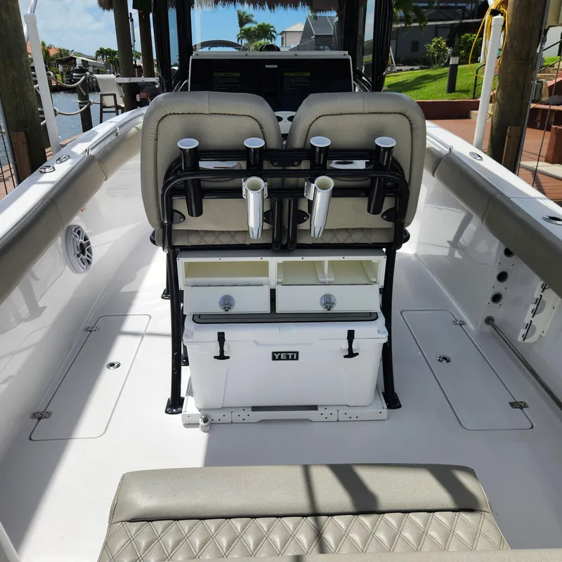 Slide: The Image of 2021 Sportsman Open 252 Center Console boat interior with Yeti cooler and rod holders. - 28