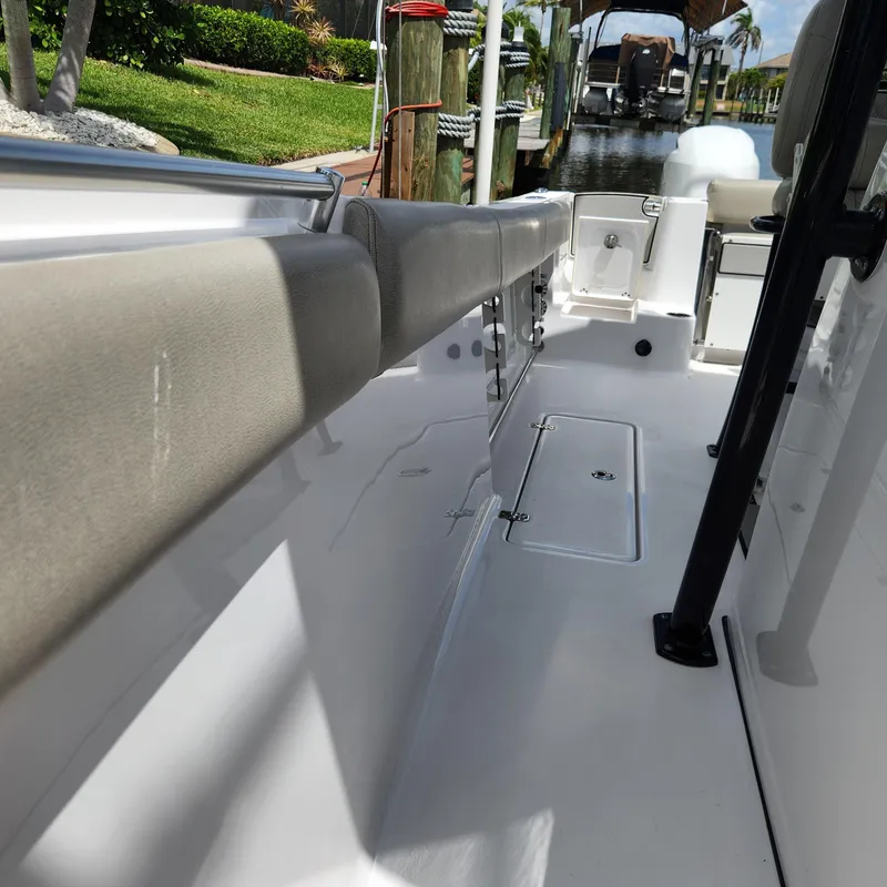 Slide: The Image of 2021 Sportsman Open 252 Center Console boat interior with seating and storage. - 31