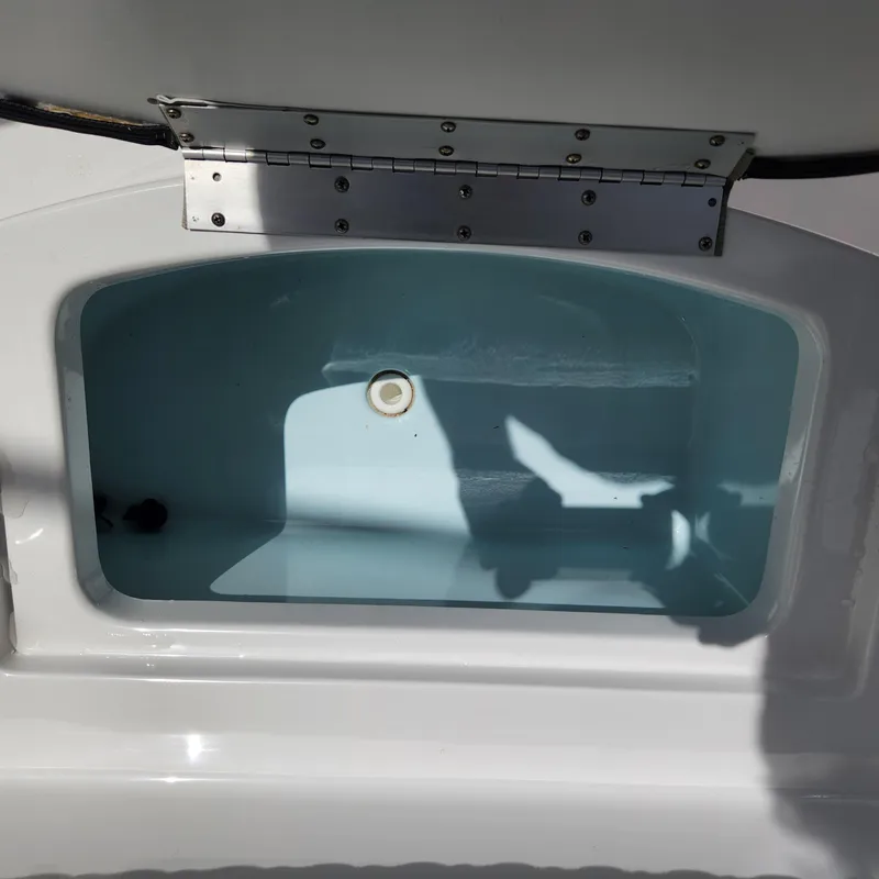 Slide: The Image of Open livewell compartment on 2021 Sportsman Open 252 Center Console boat. - 32