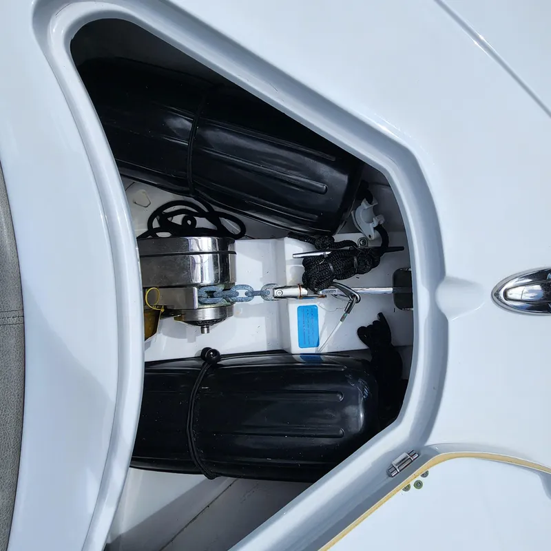 Slide: The Image of Storage compartment of a 2021 Sportsman Open 252 Center Console boat with fenders and anchor. - 33