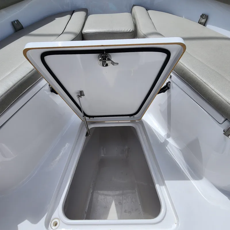 Slide: The Image of Open storage compartment on 2021 Sportsman Open 252 Center Console boat. - 37