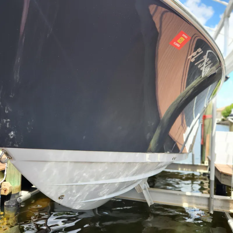 Slide: The Image of 2021 Sportsman Open 252 Center Console boat on a lift, reflecting water. - 4