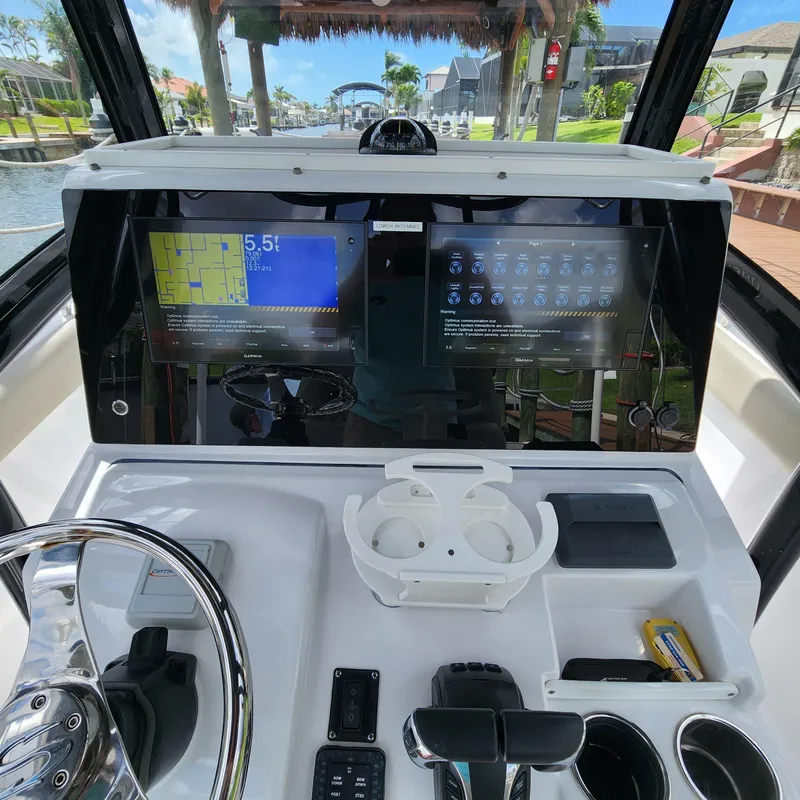 Slide: The Image of 2021 Sportsman Open 252 Center Console dashboard with dual displays and controls. - 40