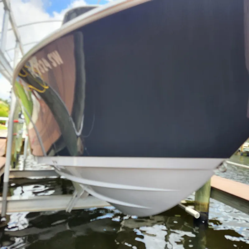 Slide: The Image of 2021 Sportsman Open 252 Center Console boat docked on a lift. - 5