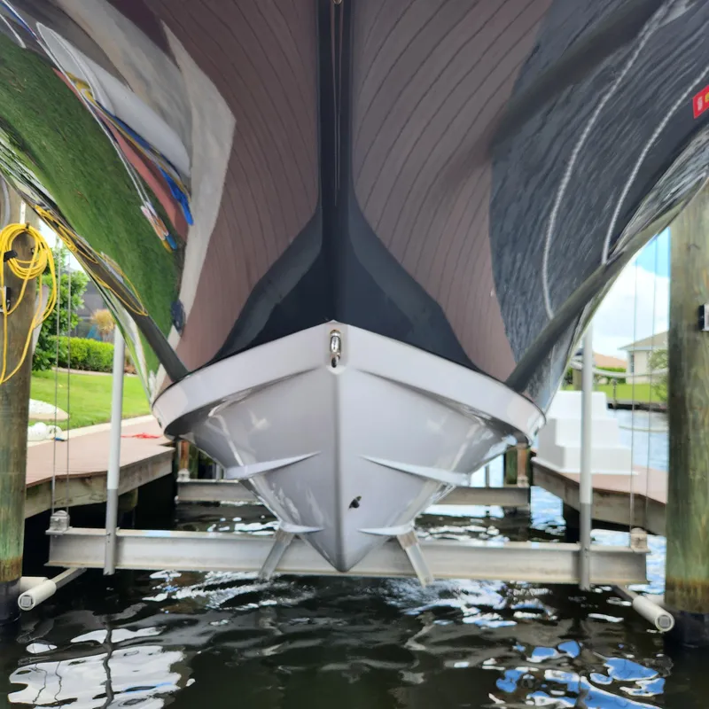 Slide: The Image of 2021 Sportsman Open 252 Center Console boat on lift, viewed from below. - 6