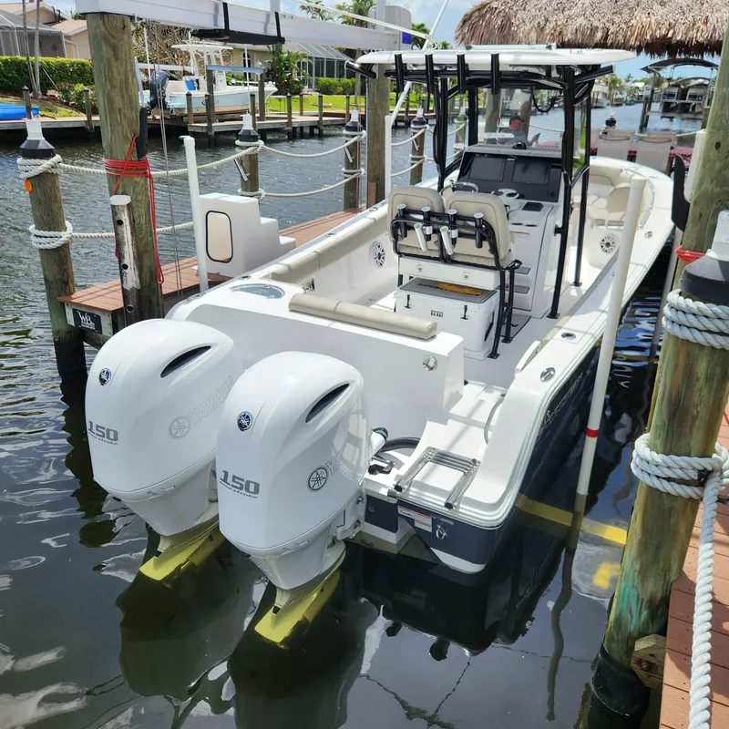 Slide: The Image of 2021 Sportsman Open 252 Center Console boat docked with dual engines. - 9