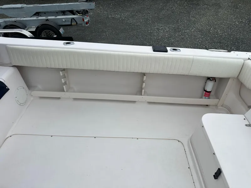Slide: The Image of 2001 Grady-White Sailfish 282 boat interior with white seating and storage area. - 10