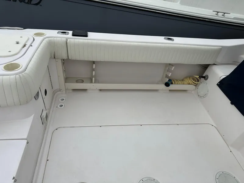 Slide: The Image of 2001 Grady-White Sailfish 282 boat interior, featuring spacious seating and storage area. - 12