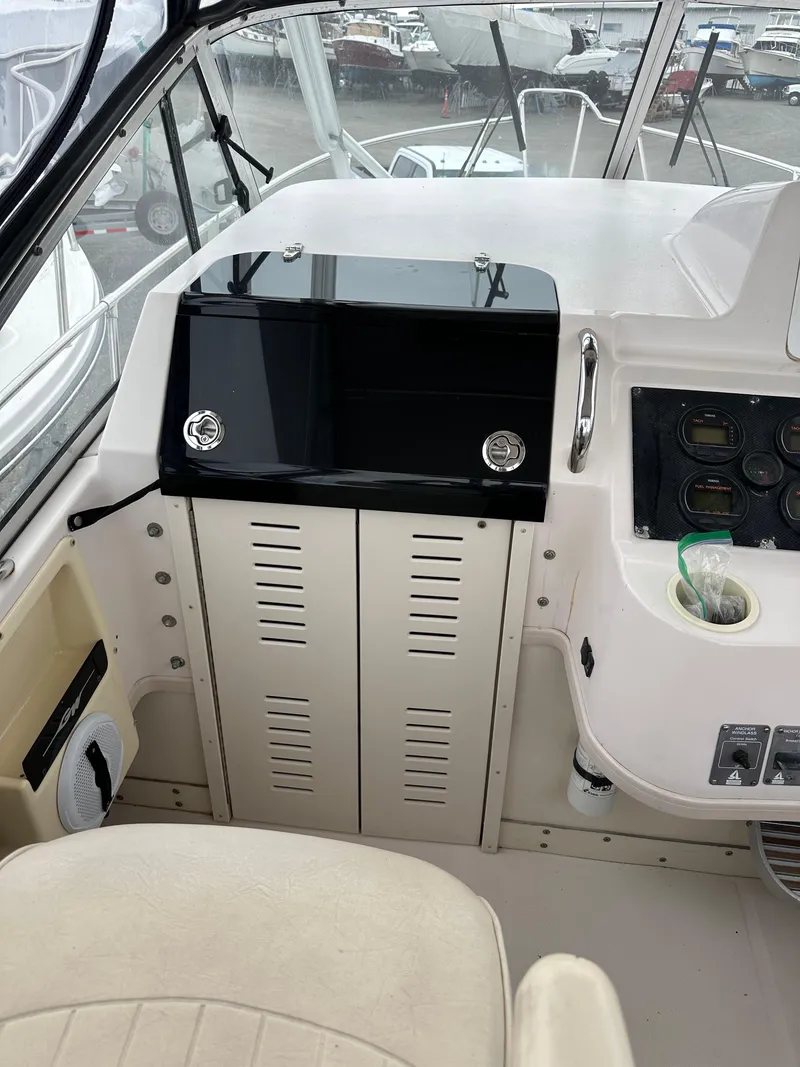 Slide: The Image of 2001 Grady-White Sailfish 282 boat interior with control panel and seating. - 17