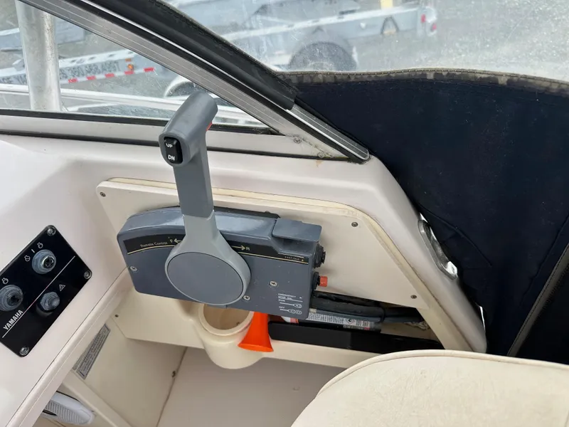 Slide: The Image of Control panel of a 2001 Grady-White Sailfish 282 boat, featuring throttle and switches. - 19