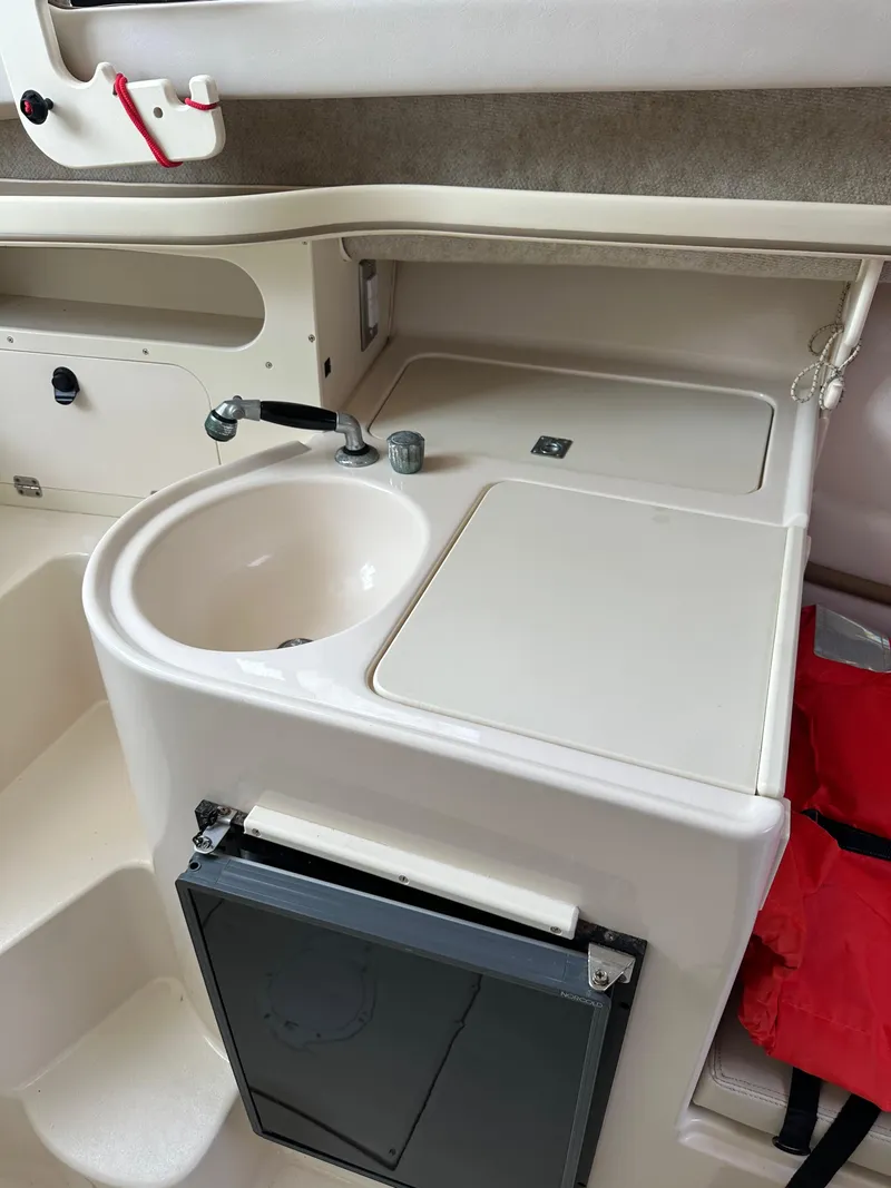 Slide: The Image of 2001 Grady-White Sailfish 282 boat interior with sink and storage area. - 27