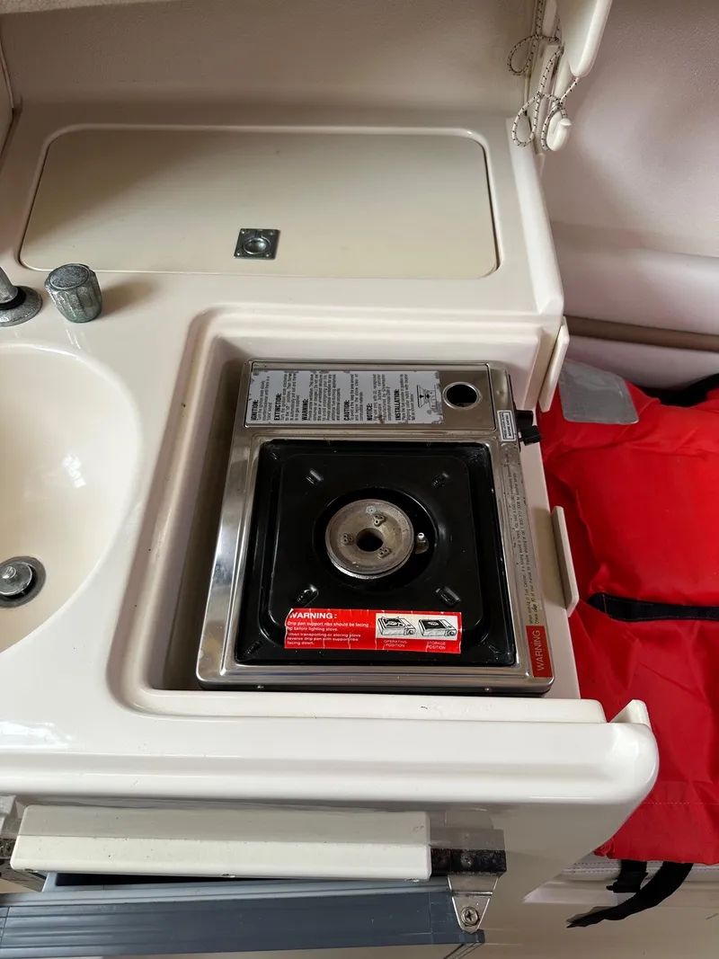 Slide: The Image of 2001 Grady-White Sailfish 282 boat kitchen with stove and sink. - 28