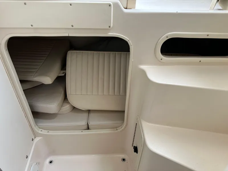 Slide: The Image of 2001 Grady-White Sailfish 282 cabin interior with cushioned seating and storage. - 31
