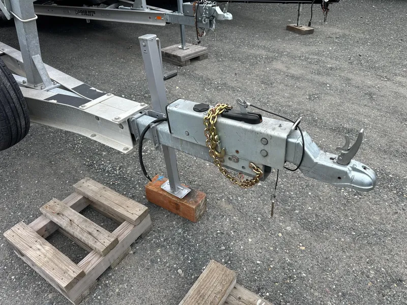 Slide: The Image of Trailer hitch for 2001 Grady-White Sailfish 282 boat, secured with chain on gravel surface. - 38