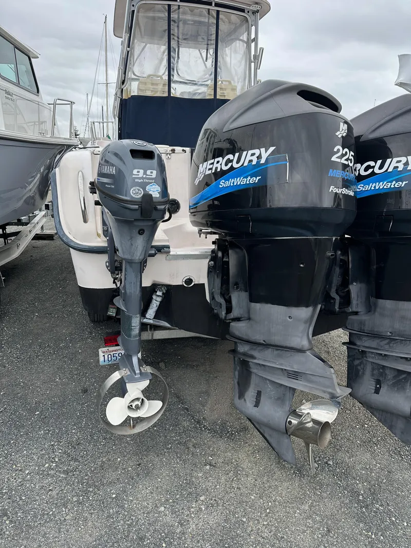 Slide: The Image of 2001 Grady-White Sailfish 282 with dual Mercury outboard engines, docked on gravel. - 6