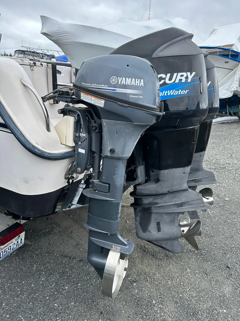 Slide: The Image of 2001 Grady-White Sailfish 282 with Yamaha and Mercury outboard motors, parked on gravel. - 7