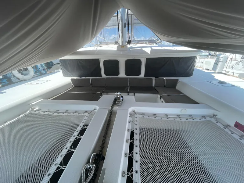 Slide: The Image of 2016 Lagoon 450 F catamaran deck with netting and seating area. - 15