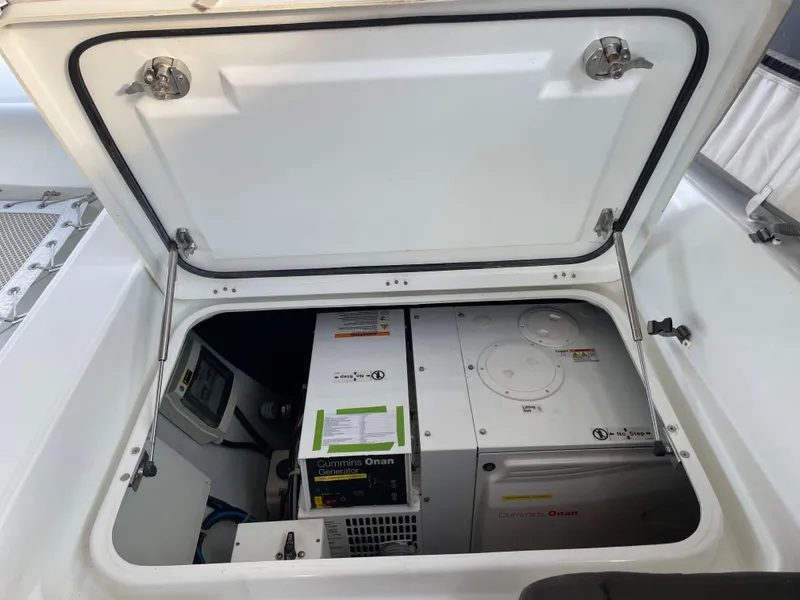 Slide: The Image of Open engine compartment of 2016 Lagoon 450 F catamaran showing Cummins Onan generator. - 17