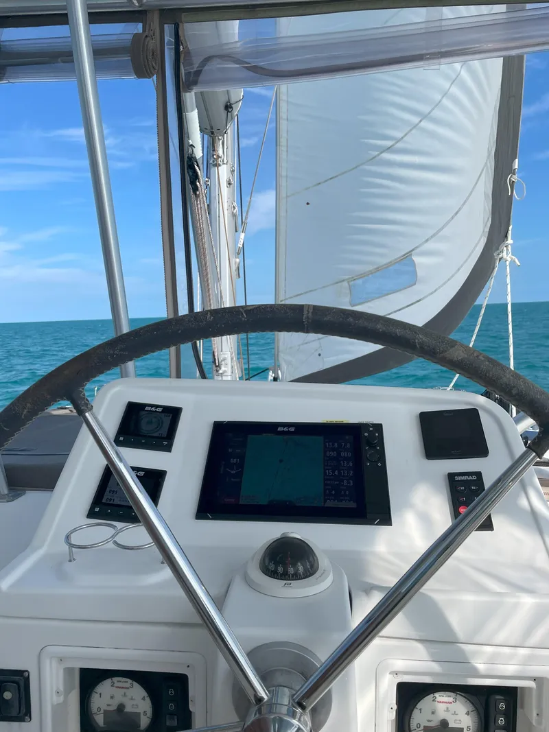 Slide: The Image of Helm of 2016 Lagoon 450 F catamaran with ocean view and sails. - 26